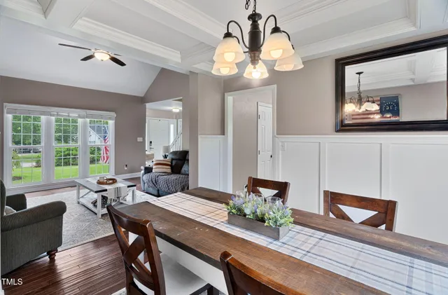 a view of a dining room with furniture wooden floor and chandelier