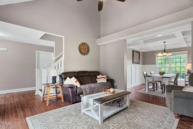 a living room with furniture wooden floor and a table