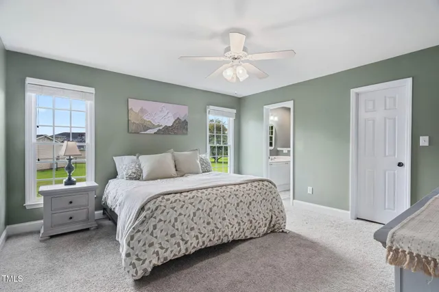 a bedroom with a large bed and a chandelier