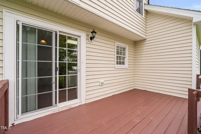 a view of a deck with wooden floor and fence