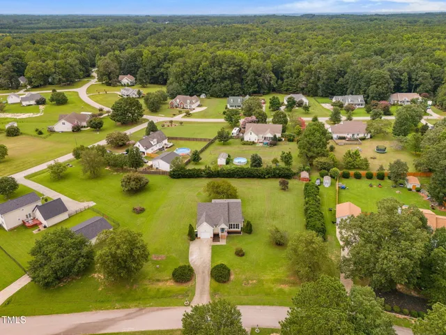 an aerial view of residential houses with outdoor space