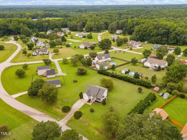 a view of an ocean boats and trees in the background