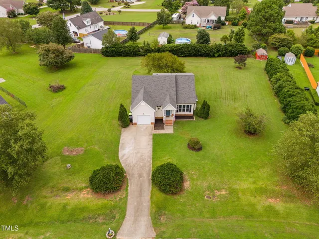 an aerial view of a residential houses with swimming pool