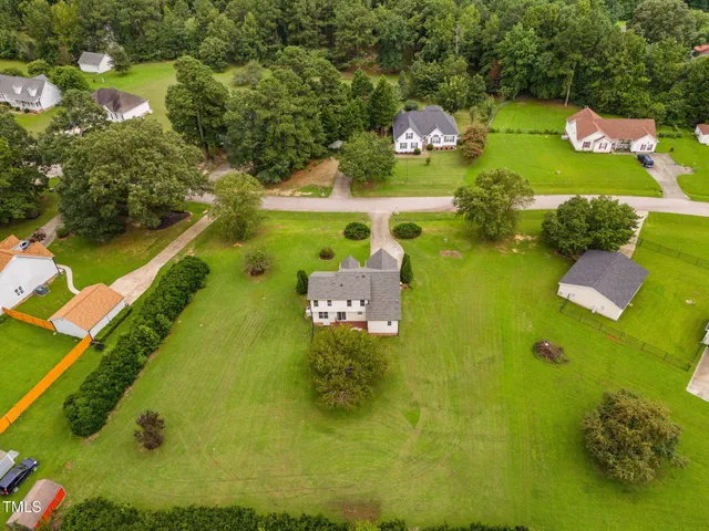 an aerial view of a house with a swimming pool