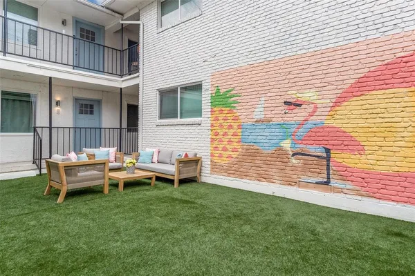 a view of a house with a backyard and sitting area