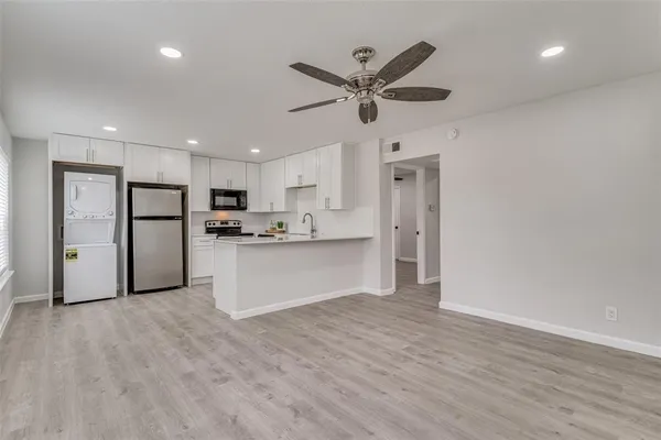 a view of a kitchen with a refrigerator and microwave