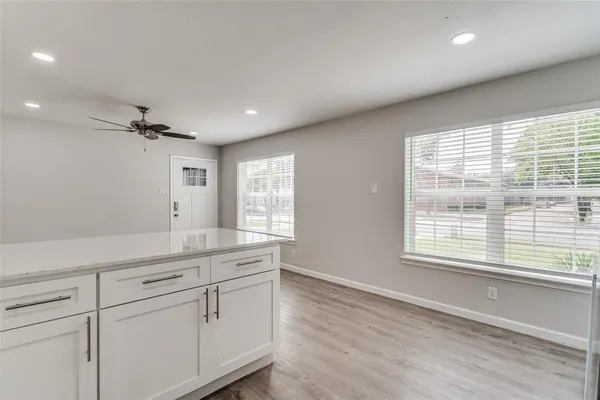 a living room with hard wood floors and a window