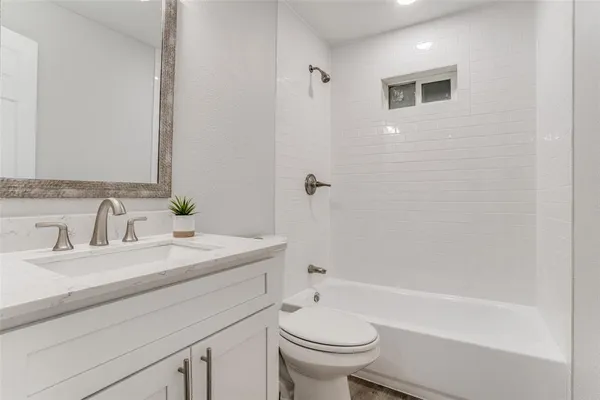 a bathroom with a sink a toilet and a bathtub