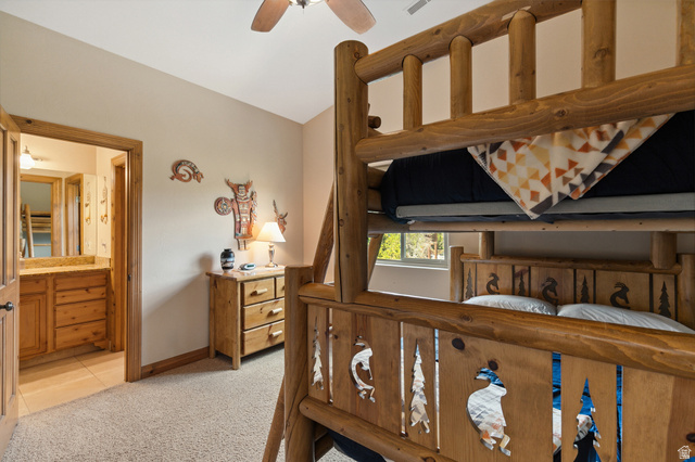 755 South Zion Ridge Drive Orderville, UT 84758 - Photo 55 of 84 Bedroom featuring light colored carpet, lofted ceiling, connected bathroom, ceiling fan, and light tile patterned floors