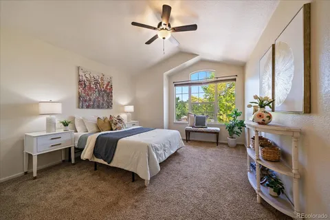 a bedroom with bed and a chandelier