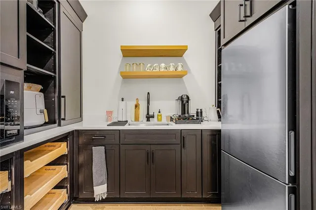a kitchen with a sink cabinets and a window