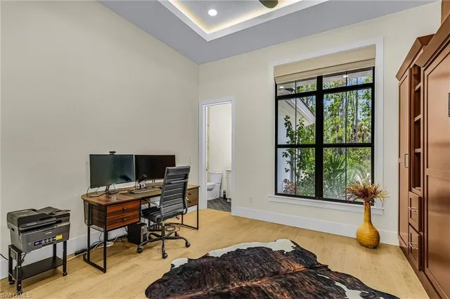 a bedroom with a bed and large window