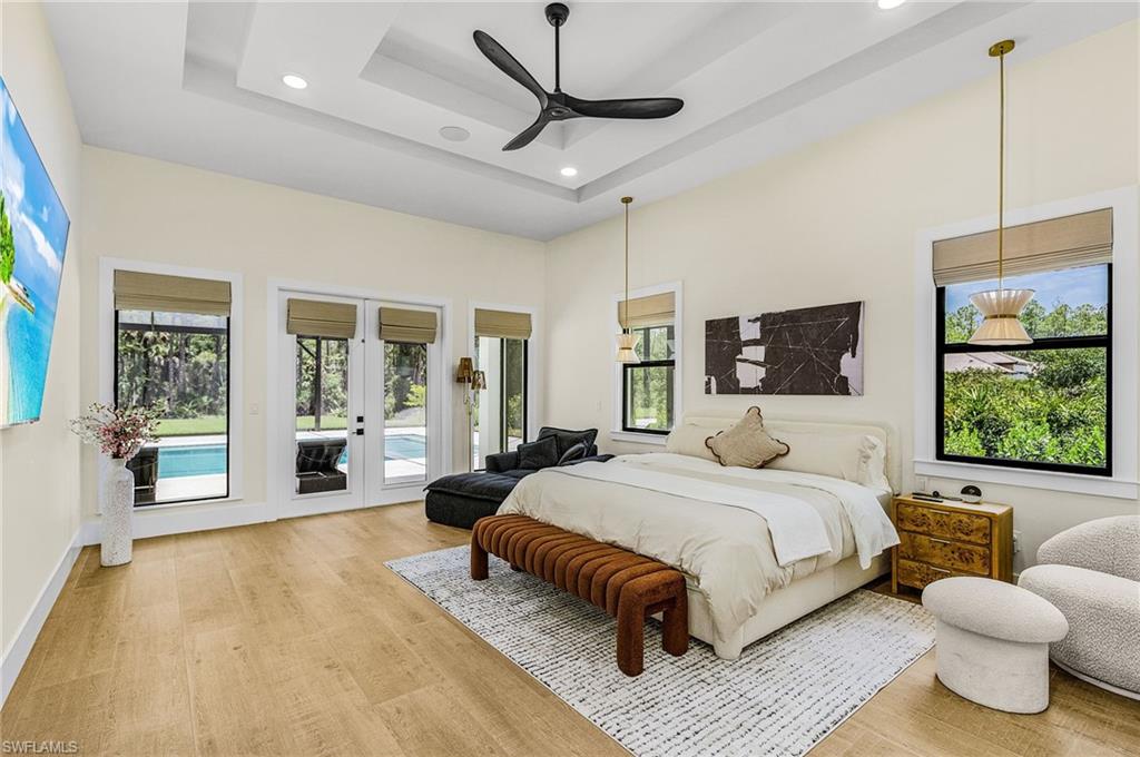 618 31st Street Northwest Naples, FL 34117 - Photo 15 of 47 a spacious bedroom with a bed and wooden floor
