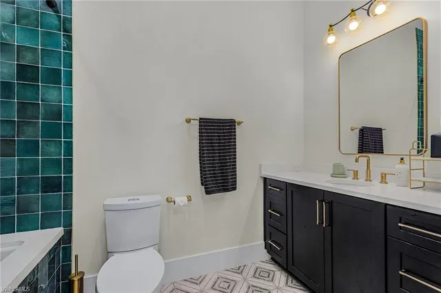 a bathroom with a toilet a sink and mirror