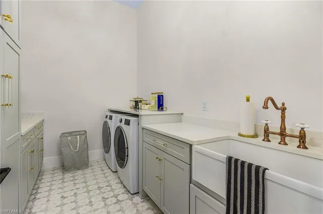 a utility room with sink dryer and washer