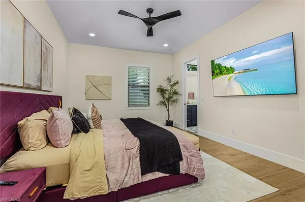 a bedroom with a bed and wooden floor