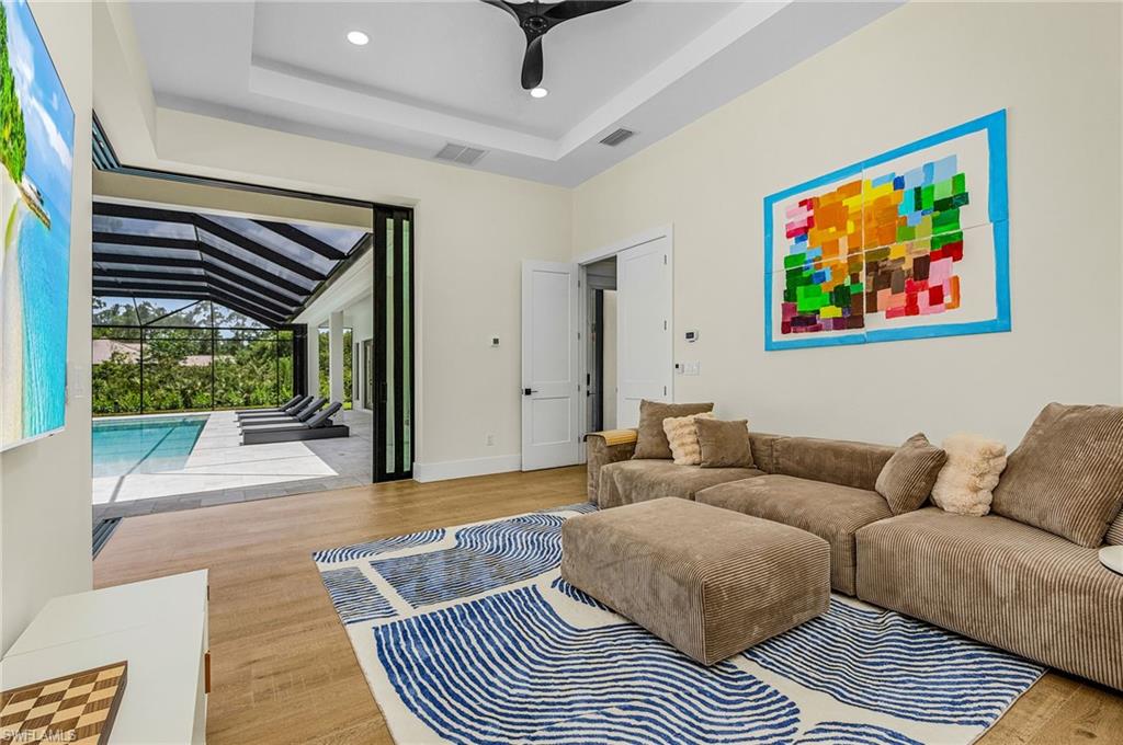 618 31st Street Northwest Naples, FL 34117 - Photo 34 of 47 a living room with furniture and a large window