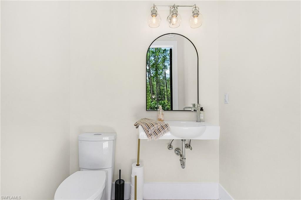 618 31st Street Northwest Naples, FL 34117 - Photo 35 of 47 a bathroom with a sink and a mirror