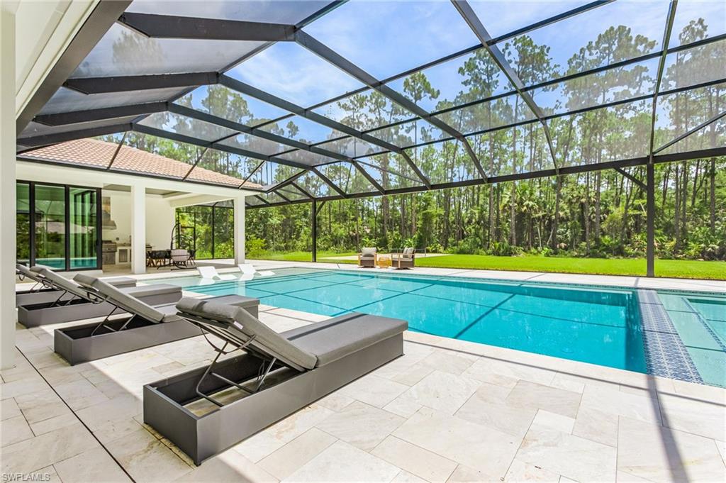 618 31st Street Northwest Naples, FL 34117 - Photo 37 of 47 a outdoor space with swimming pool and furniture