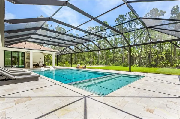 a view of a backyard with a swimming pool