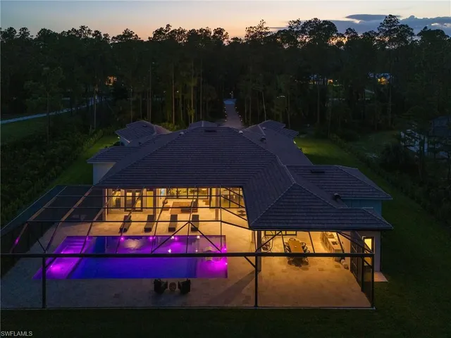 a view of swimming pool in front of residential houses with outdoor space