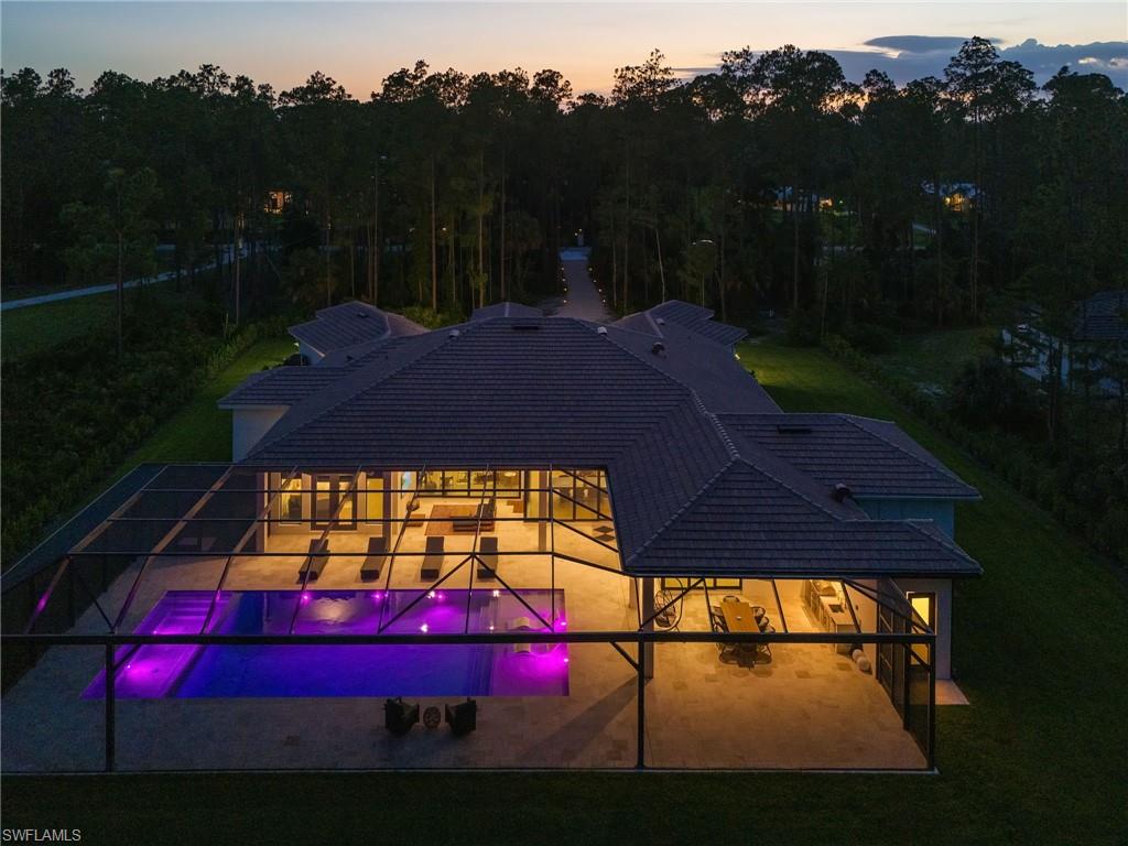 618 31st Street Northwest Naples, FL 34117 - Photo 4 of 47 a view of swimming pool in front of residential houses with outdoor space