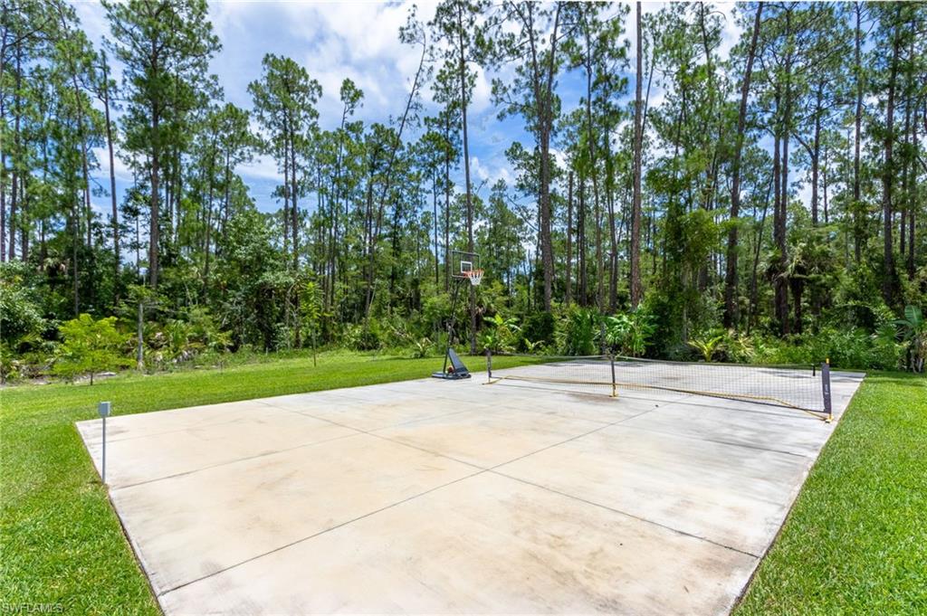 618 31st Street Northwest Naples, FL 34117 - Photo 42 of 47 a view of a yard with plants and trees