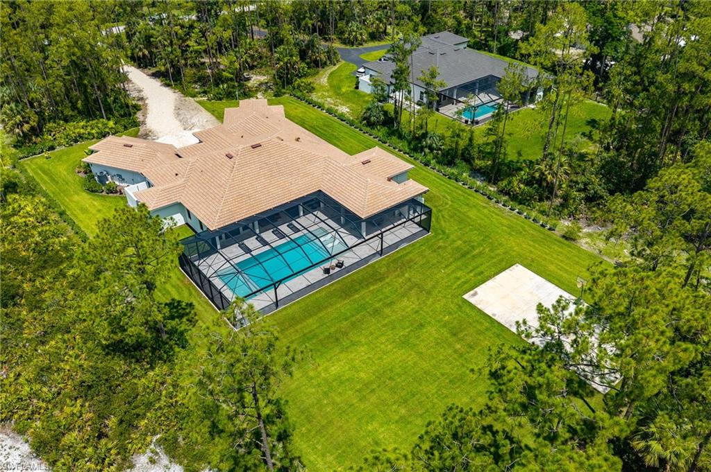 618 31st Street Northwest Naples, FL 34117 - Photo 44 of 47 an aerial view of a house with pool yard and outdoor seating