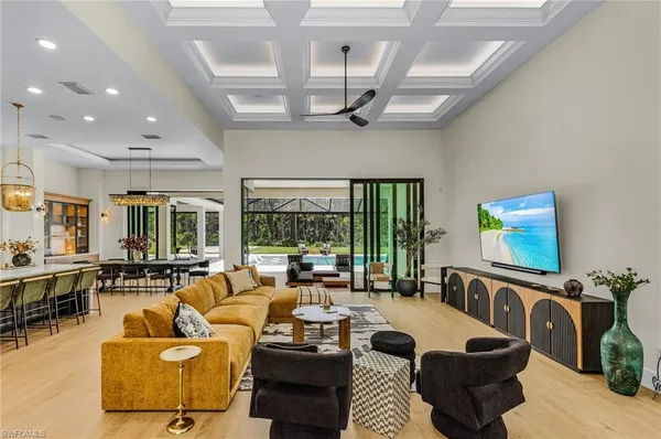 a living room with furniture wooden floor and a large window