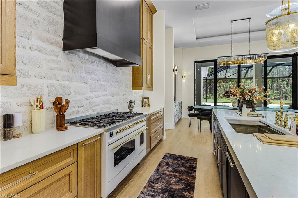 618 31st Street Northwest Naples, FL 34117 - Photo 8 of 47 a kitchen with stainless steel appliances a stove a sink and cabinets