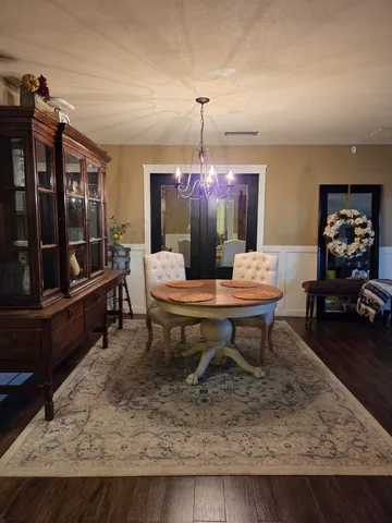 a living room with furniture a rug and a large window