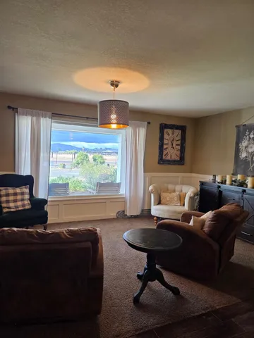 a spacious bedroom with a bed and a chandelier
