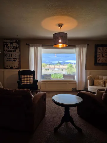 a living room with furniture and a pool table