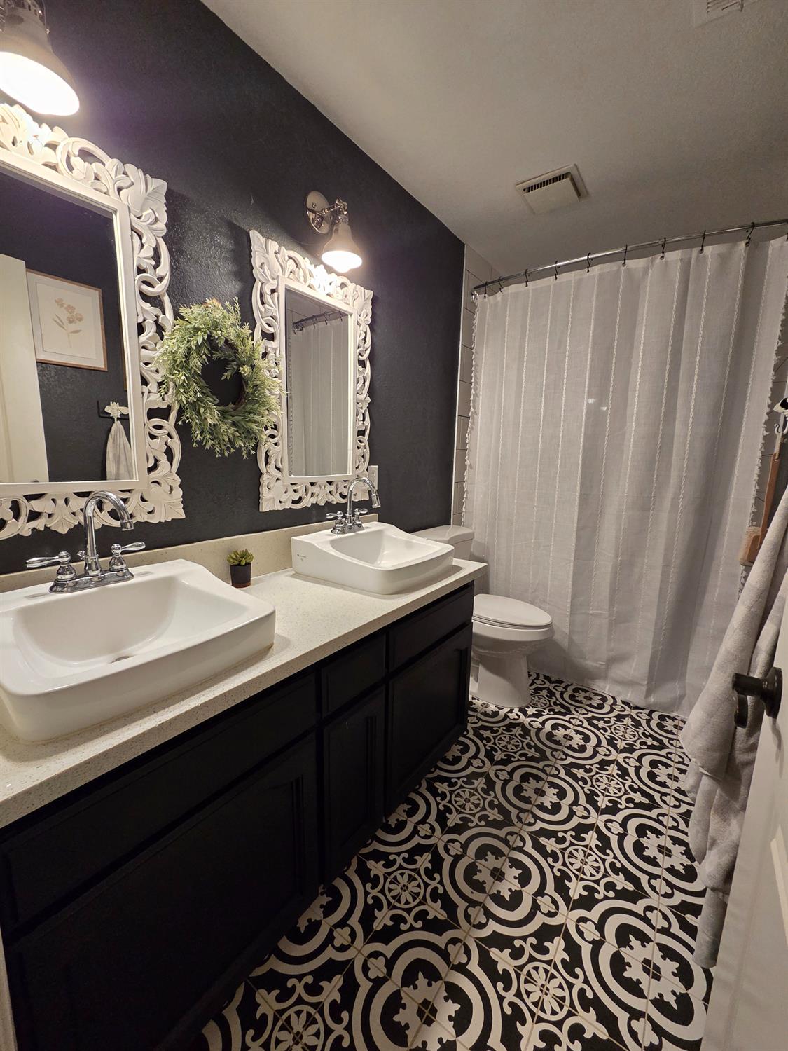 22849 East Jefferson Avenue Reedley, CA 93654 - Photo 19 of 31 a bathroom with a double vanity sink and a mirror