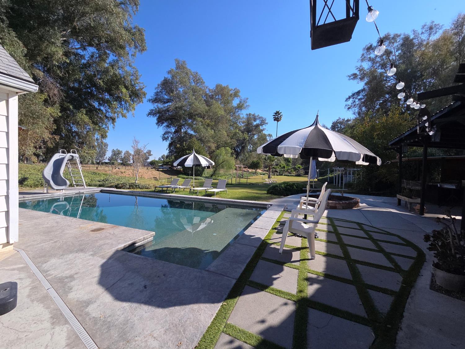 22849 East Jefferson Avenue Reedley, CA 93654 - Photo 27 of 31 a view of a swimming pool with a patio