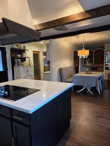 a kitchen with granite countertop a stove and a sink