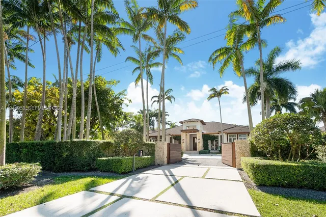 a view of a backyard with a garden and patio