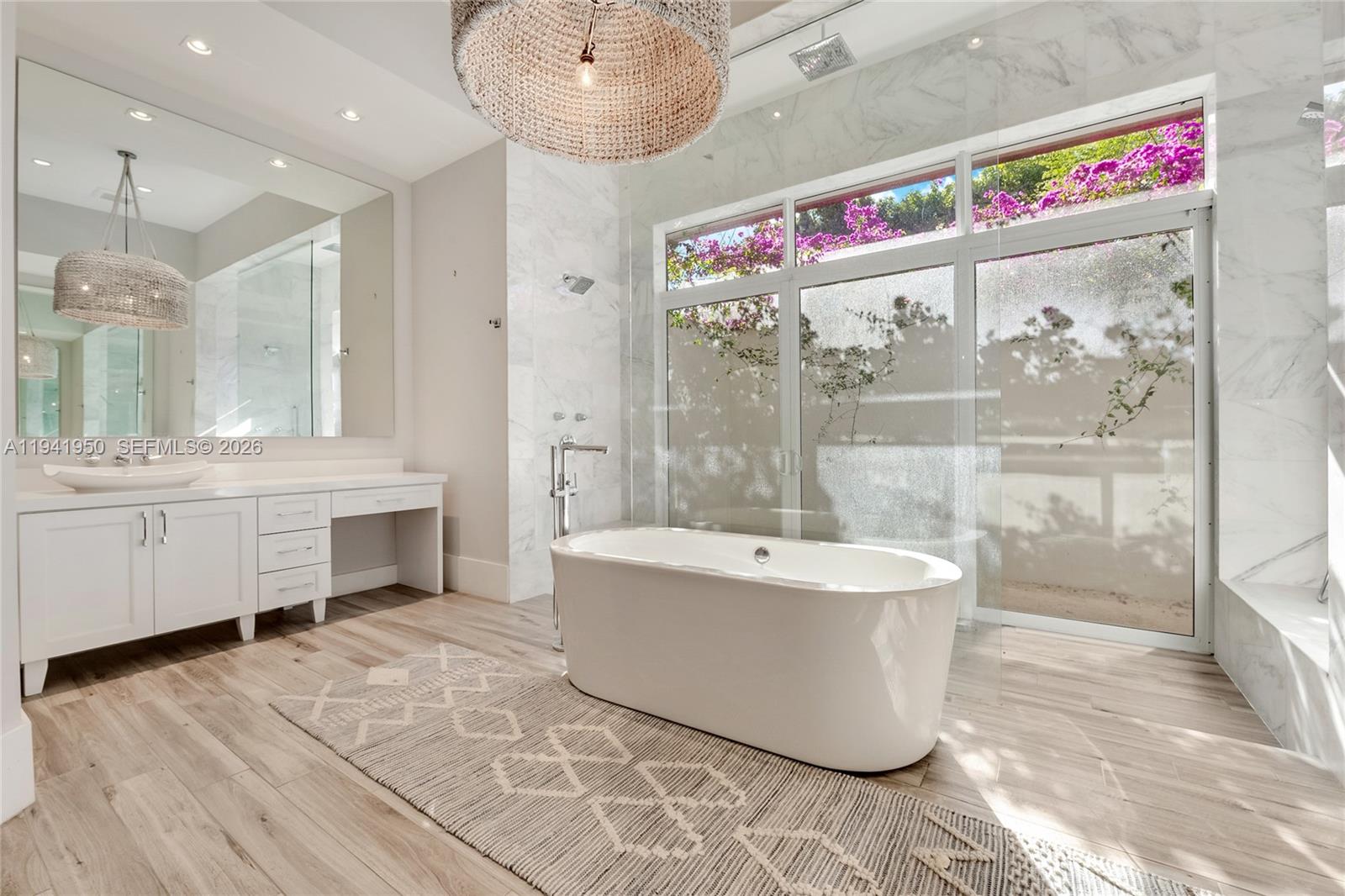 6880 Southwest 82nd Avenue Miami, FL 33143 - Photo 14 of 29 a bathroom with a tub sink shower and mirror