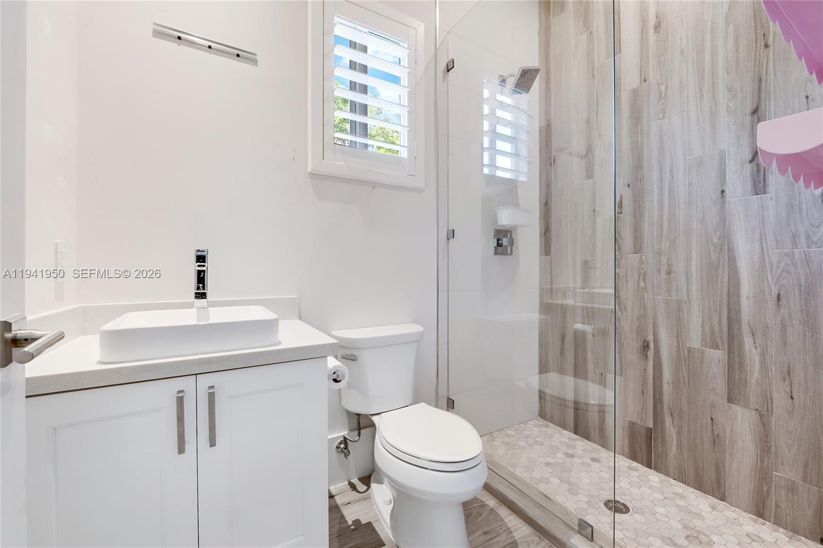 6880 Southwest 82nd Avenue Miami, FL 33143 - Photo 16 of 29 a bathroom with a sink a toilet and shower