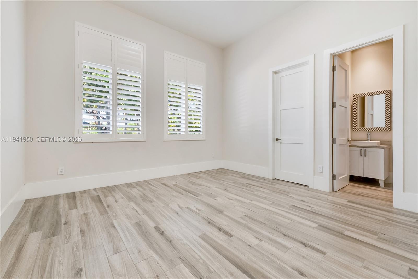 6880 Southwest 82nd Avenue Miami, FL 33143 - Photo 19 of 29 an empty room with wooden floor and windows