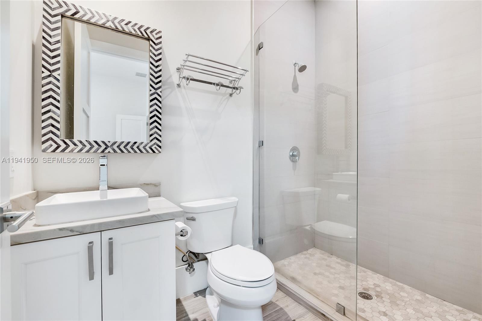 6880 Southwest 82nd Avenue Miami, FL 33143 - Photo 20 of 29 a white toilet sitting next to a bathroom sink