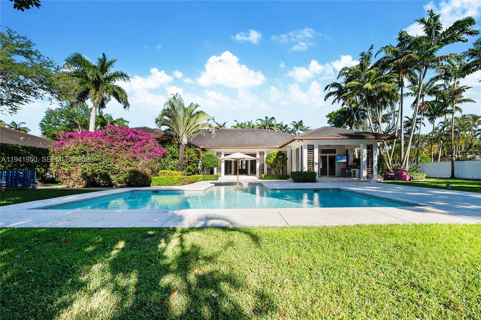 6880 Southwest 82nd Avenue Miami, FL 33143 - Photo 28 of 29 a view of house with garden and swimming pool