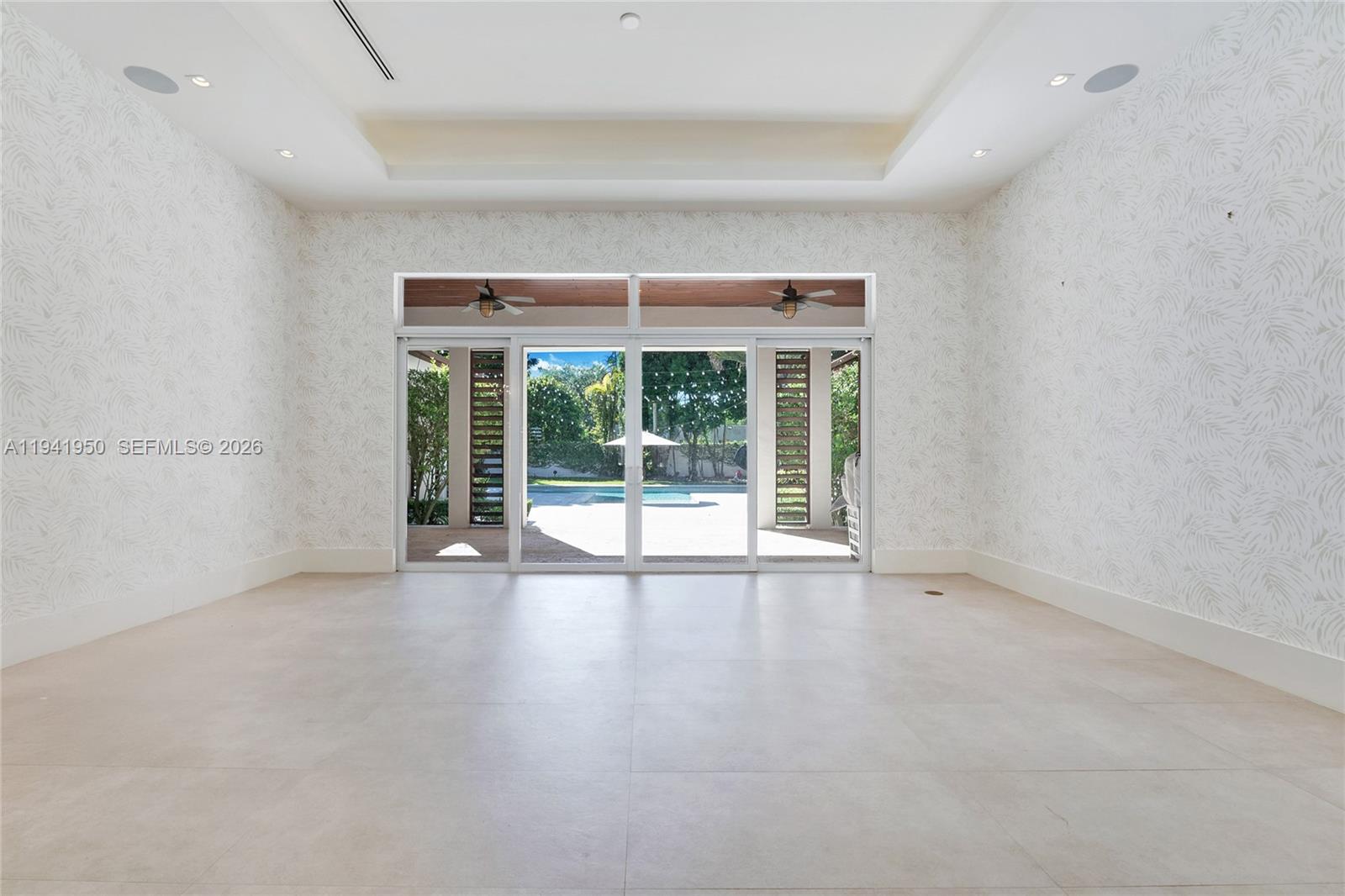 6880 Southwest 82nd Avenue Miami, FL 33143 - Photo 3 of 29 an empty room with wooden floor and windows