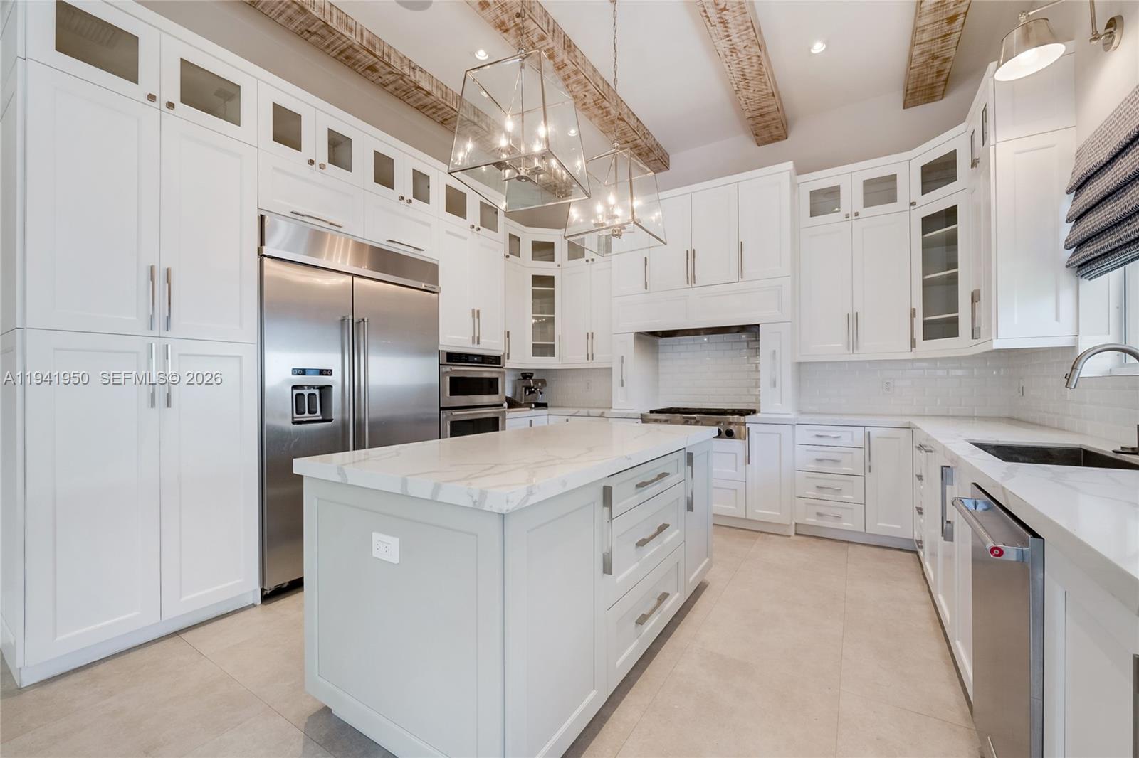 6880 Southwest 82nd Avenue Miami, FL 33143 - Photo 6 of 29 a kitchen that has a lot of white cabinets and stainless steel appliances