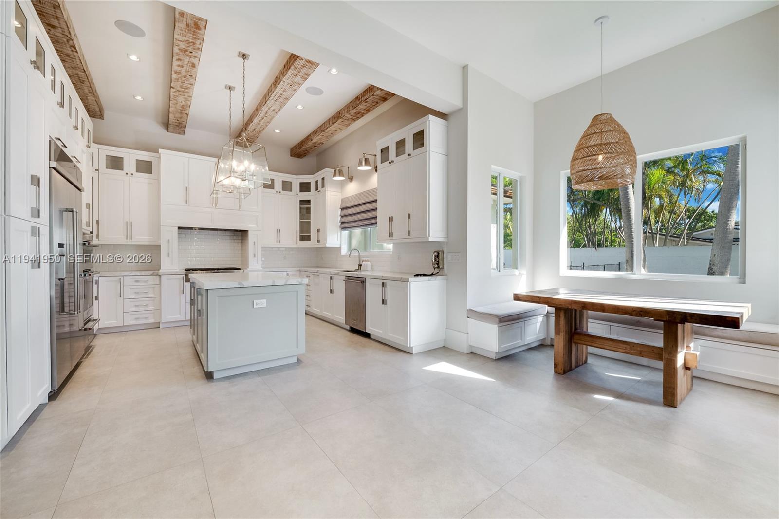6880 Southwest 82nd Avenue Miami, FL 33143 - Photo 7 of 29 a large living room with stainless steel appliances kitchen island granite countertop furniture and a large window