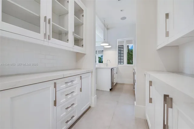 a kitchen with cabinets and window