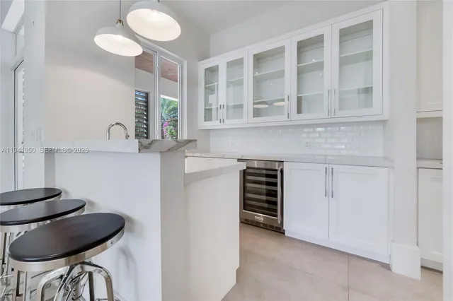 a kitchen with a table and chairs