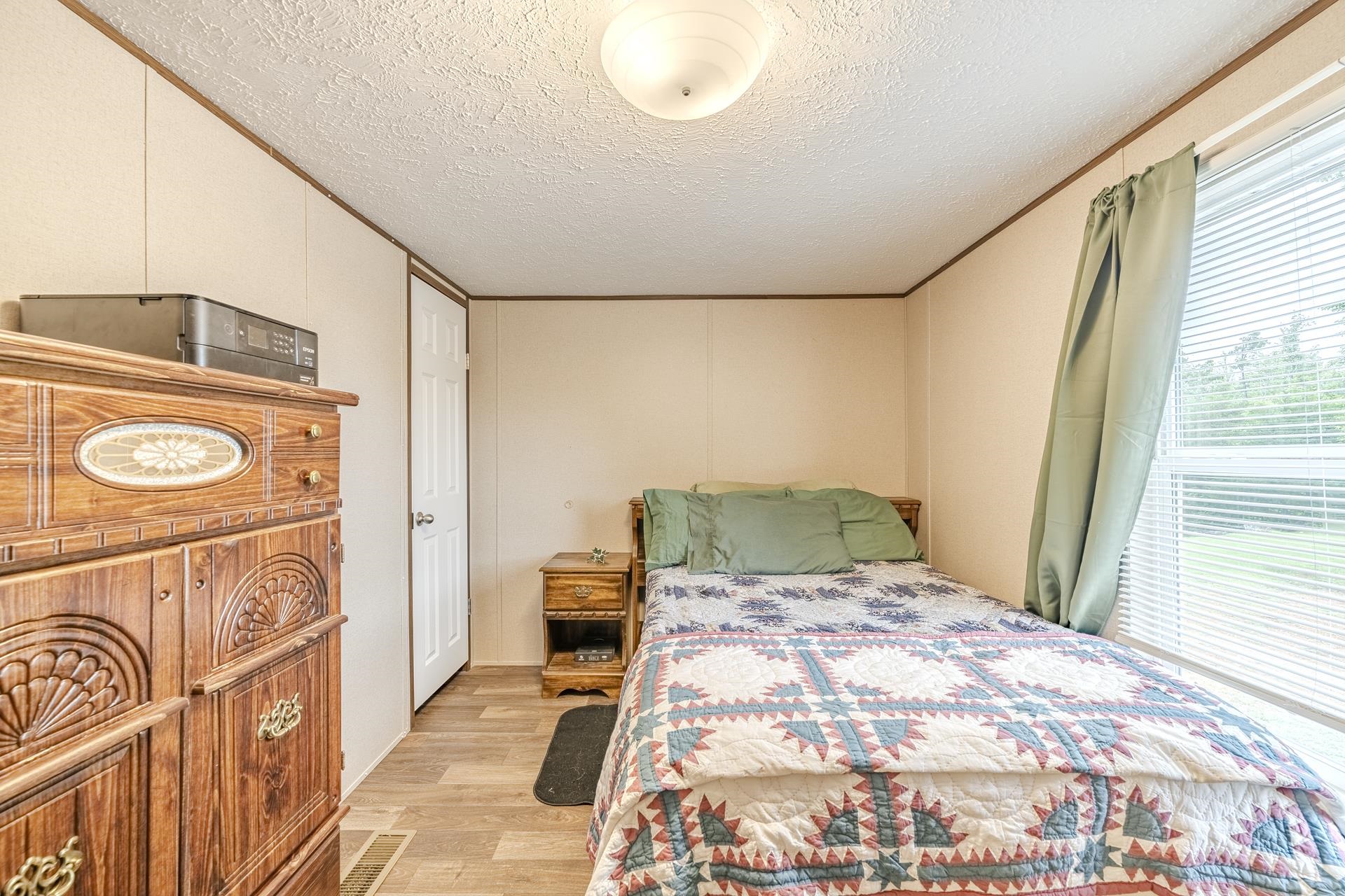 3275 Glendale Road Adamsville, TN 38310 - Photo 28 of 39 a bedroom with a bed and a window