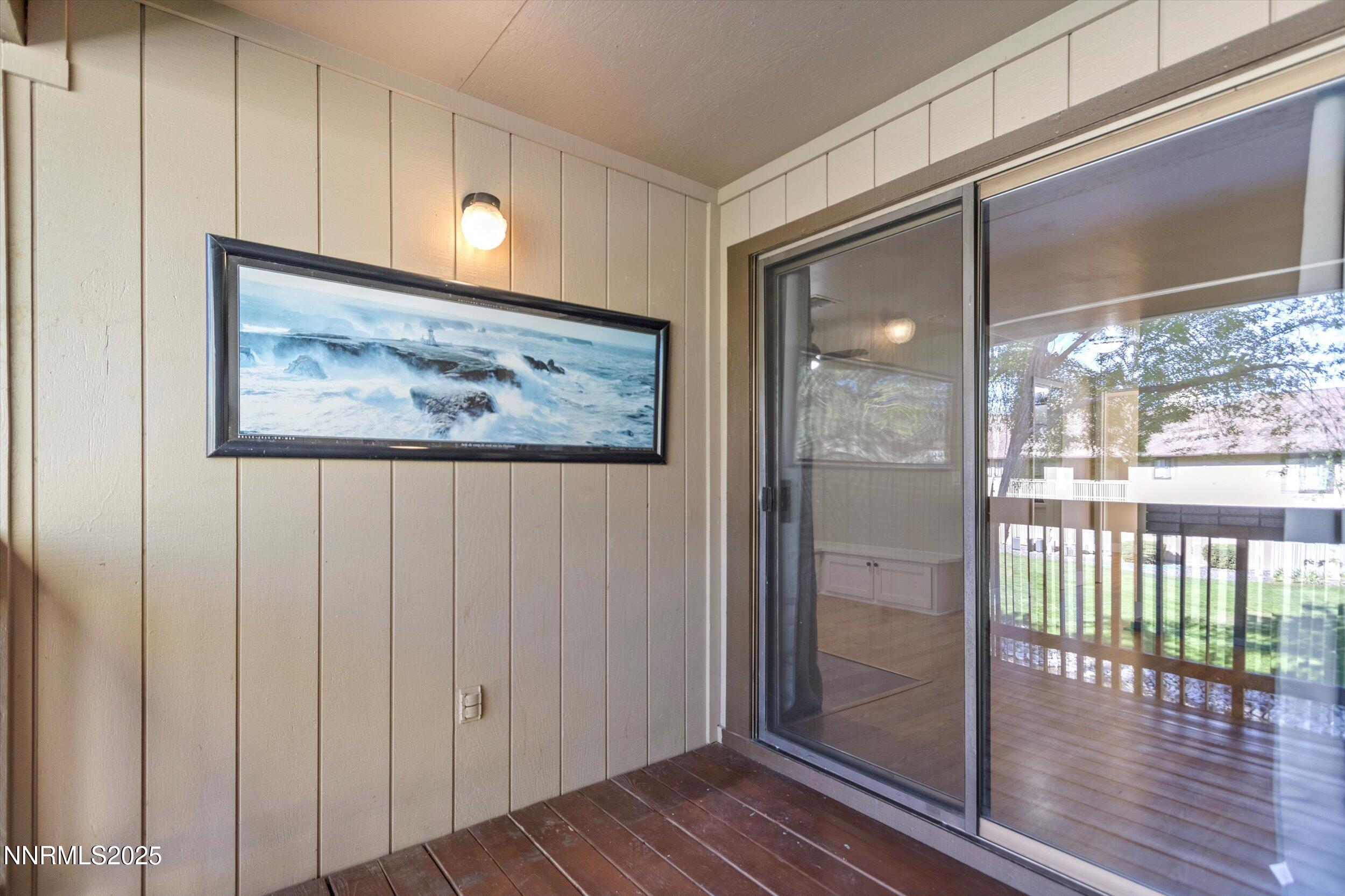 4634 Rio Poco Road Reno, NV 89502 - Photo 17 of 24 a view of a hallway with wooden floor and door