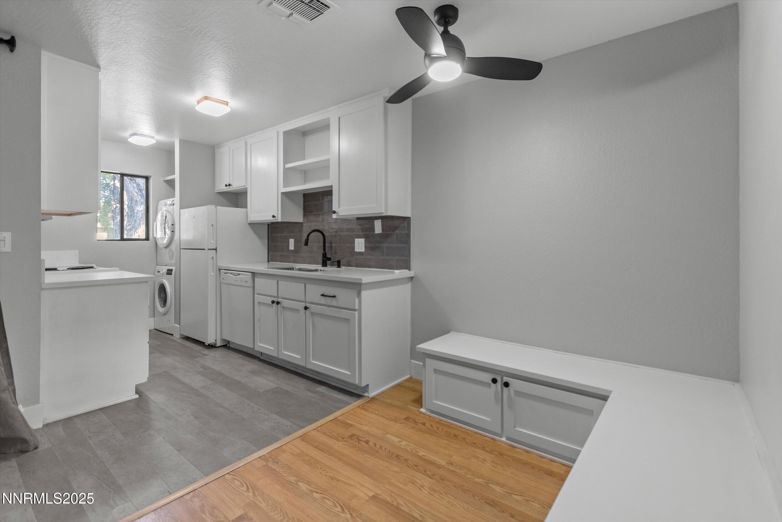 4634 Rio Poco Road Reno, NV 89502 - Photo 7 of 24 a kitchen with a sink cabinets and wooden floor